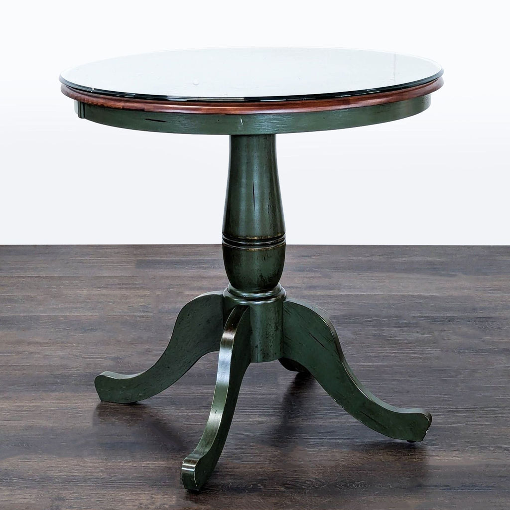 Green Pier 1 Imports end table featuring a rustic look, wooden base, and a clear glass protective top.  