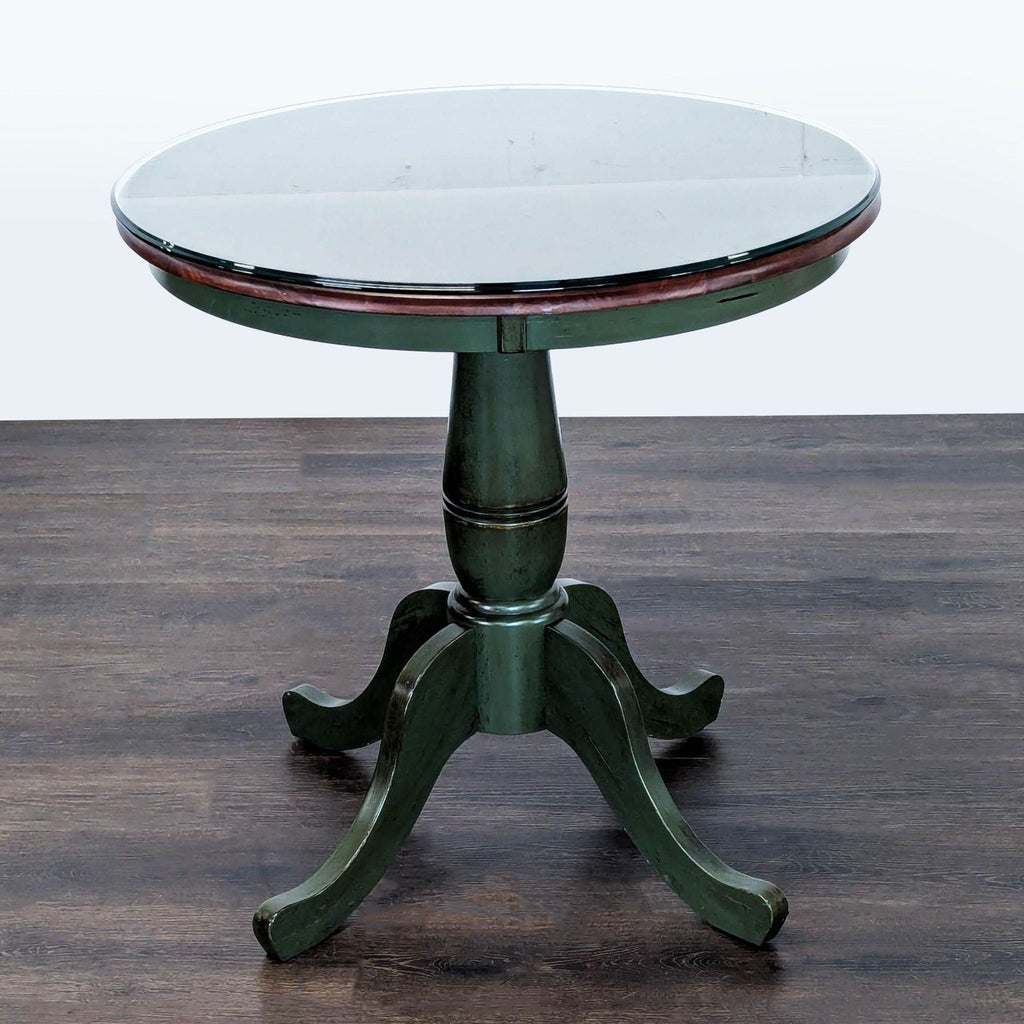 Pier 1 Imports end table with distressed green wooden legs and a glass-covered surface for durability.