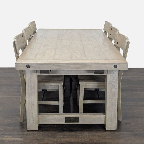 Pottery Barn dining set with a natural wood table and six matching chairs, ideal for modern or rustic decor.