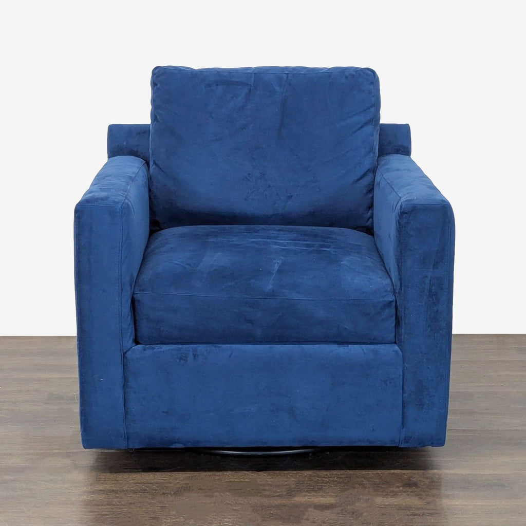 Blue velvet Crate & Barrel lounge chair with deep seat, armrests, and swivel base for modern comfort.