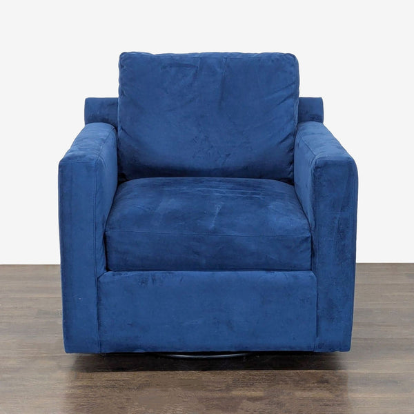 Blue velvet Crate & Barrel lounge chair with deep seat, armrests, and swivel base for modern comfort.