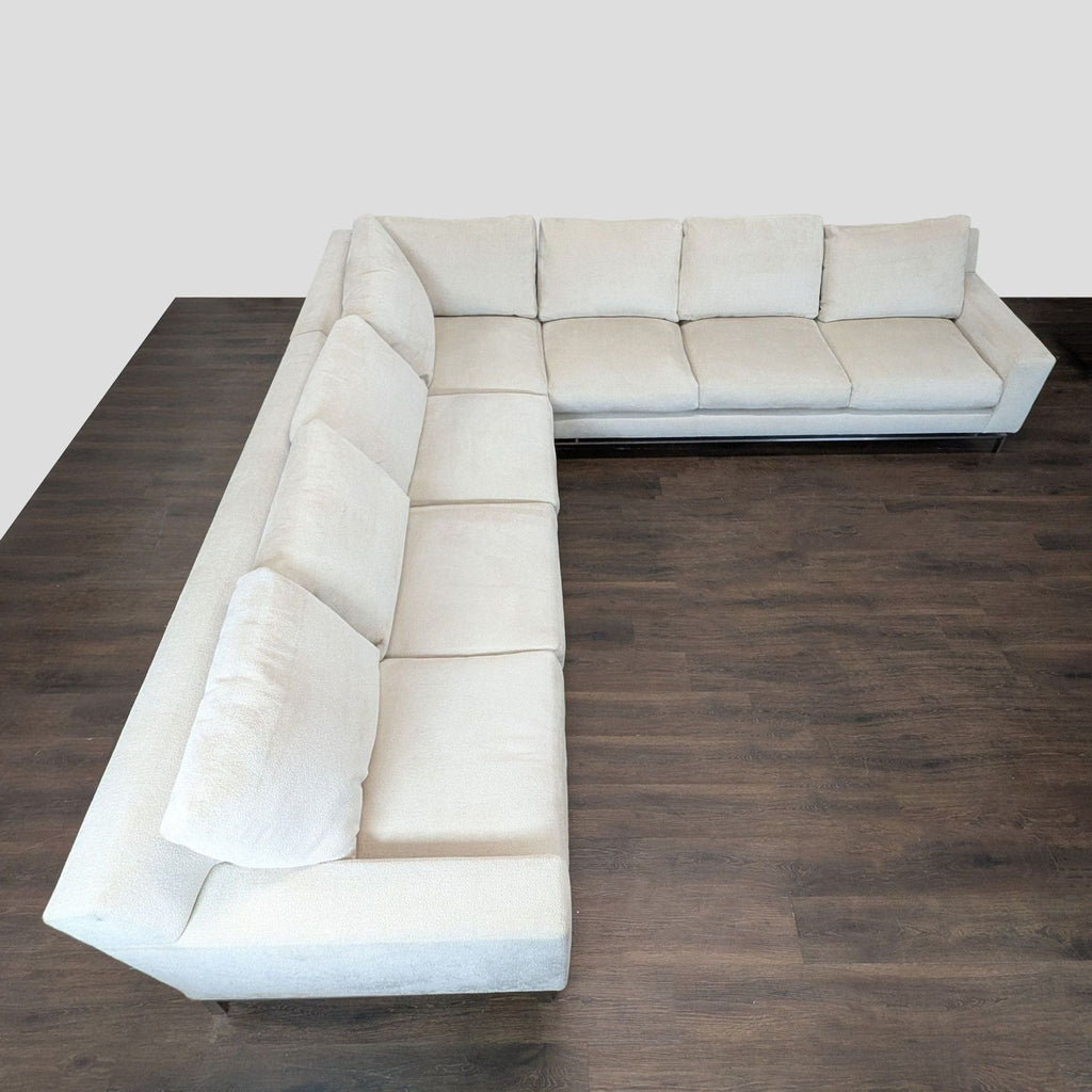 Spacious contemporary sectional with neutral beige upholstery, sturdy silver legs, and soft, supportive cushions from A. Rudin.