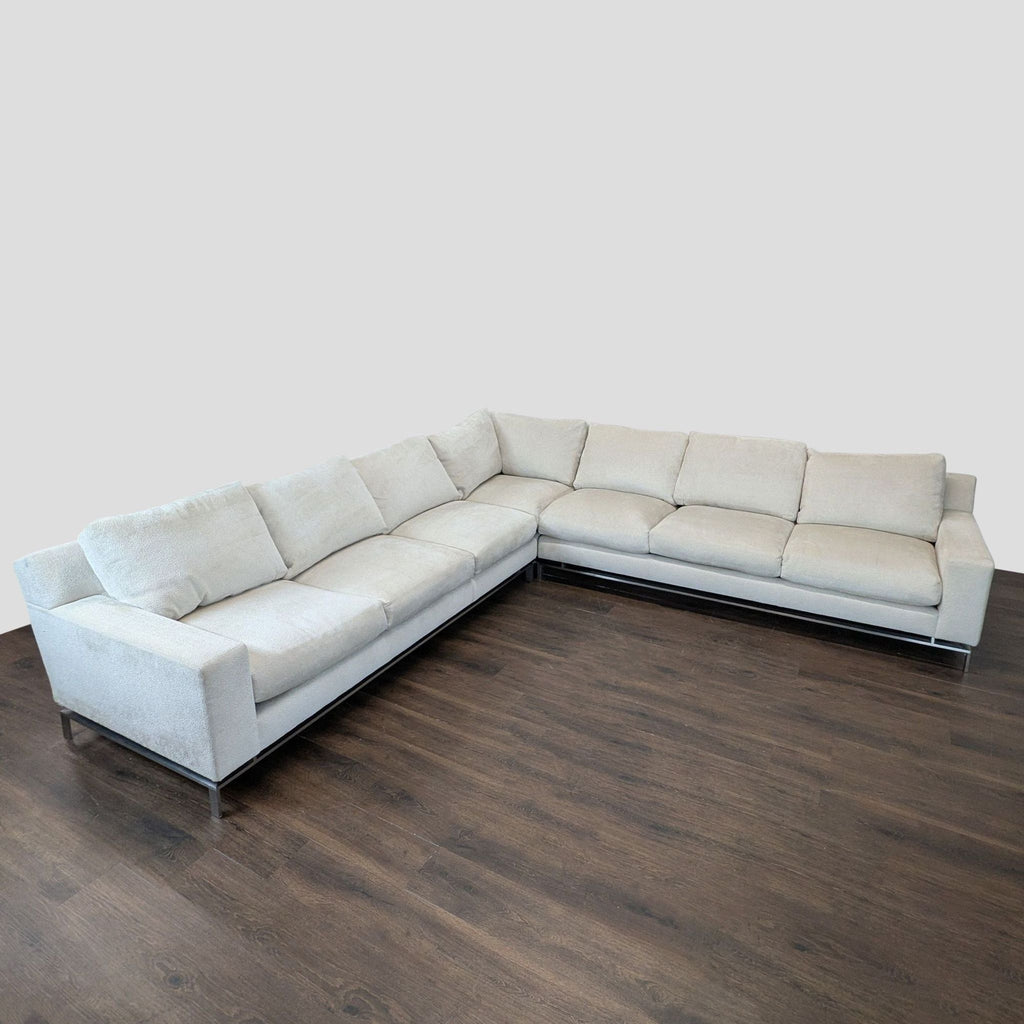 Modern A. Rudin light beige L-shaped sectional sofa with plush cushions and metal legs, ideal for group seating.