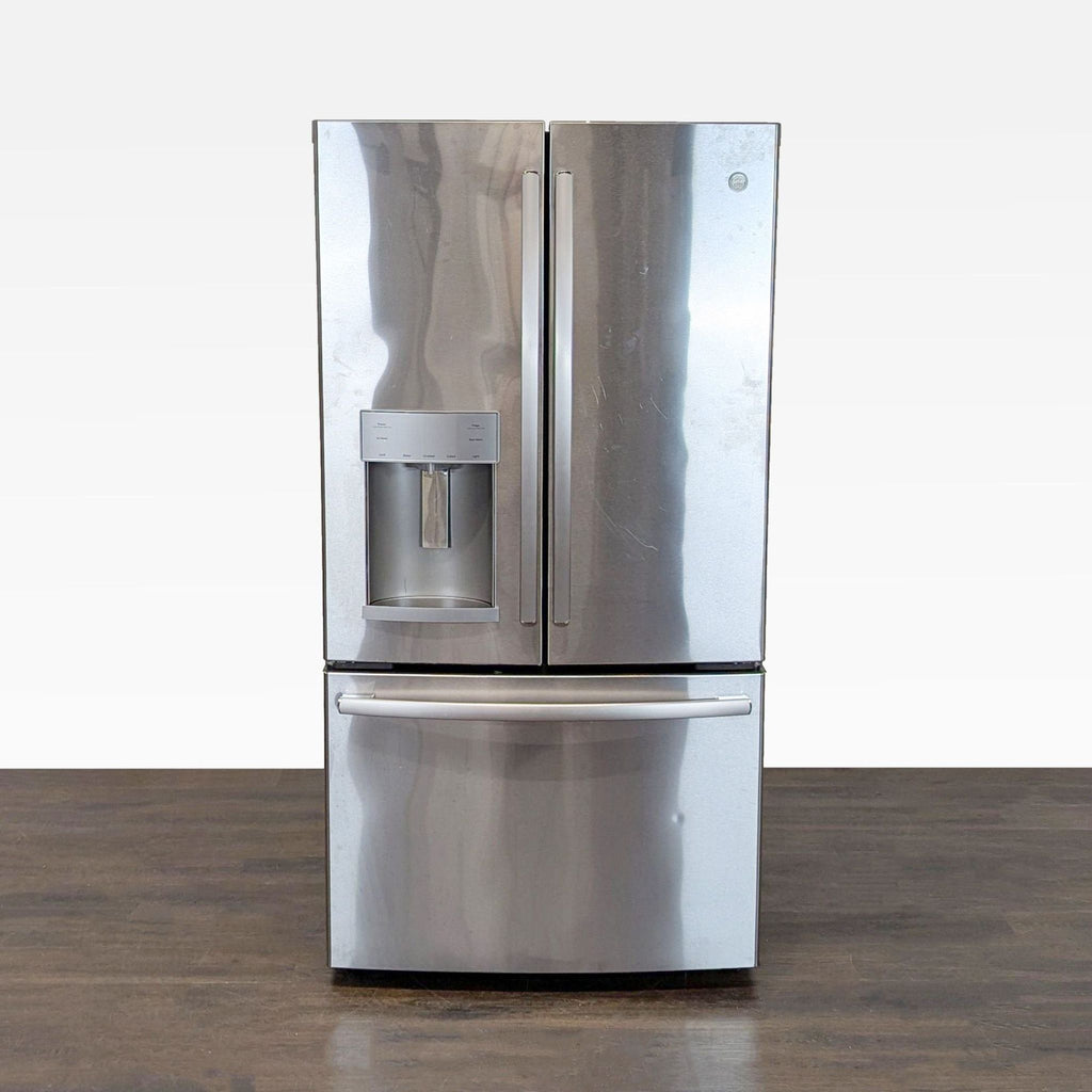 GE stainless steel French door refrigerator with bottom freezer and in-door water and ice dispenser.