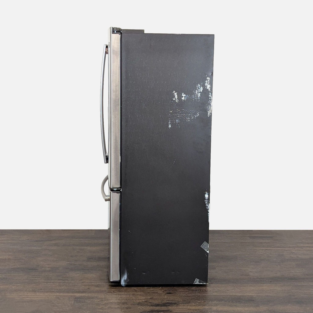 Sleek GE French door fridge with roomy bins, a bottom freezer drawer, and built-in water and ice dispenser.