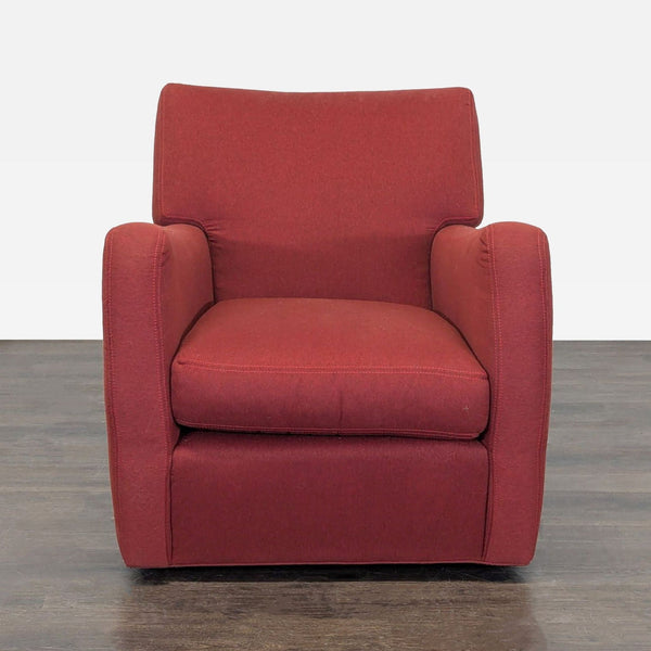 Red swivel lounge chair with plush cushioning, perfect for relaxing in living rooms or reading nooks.