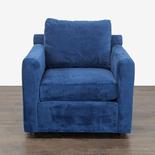 Crate & Barrel lounge chair with deep blue velvet upholstery, modern lines, and plush cushions for relaxing comfort.  