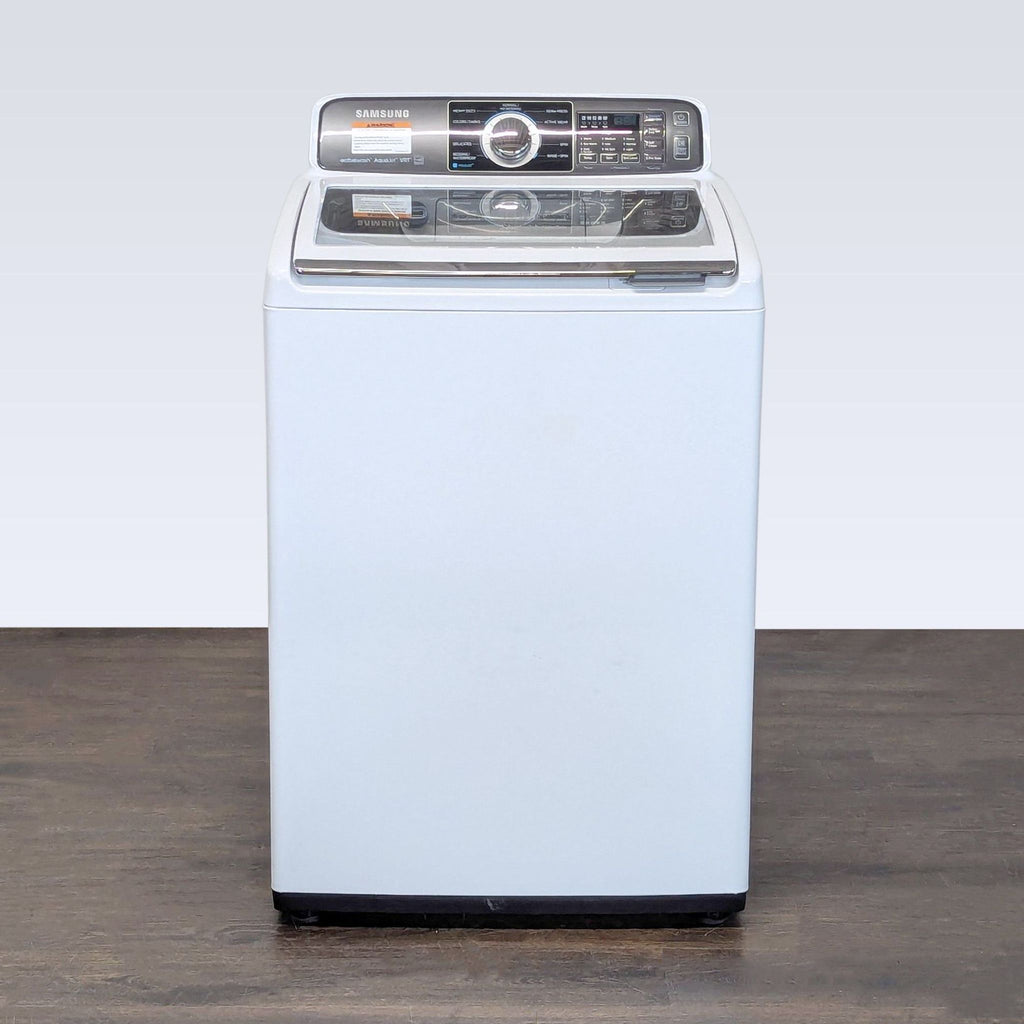 Samsung top load washer with a clear lid and user-friendly controls, ideal for compact laundry spaces.
