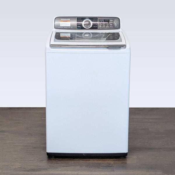 Samsung top load washer with a clear lid and user-friendly controls, ideal for compact laundry spaces.
