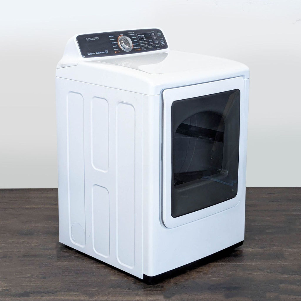 Modern white Samsung dryer featuring a see-through glass door and simple control panel for efficient laundry use.