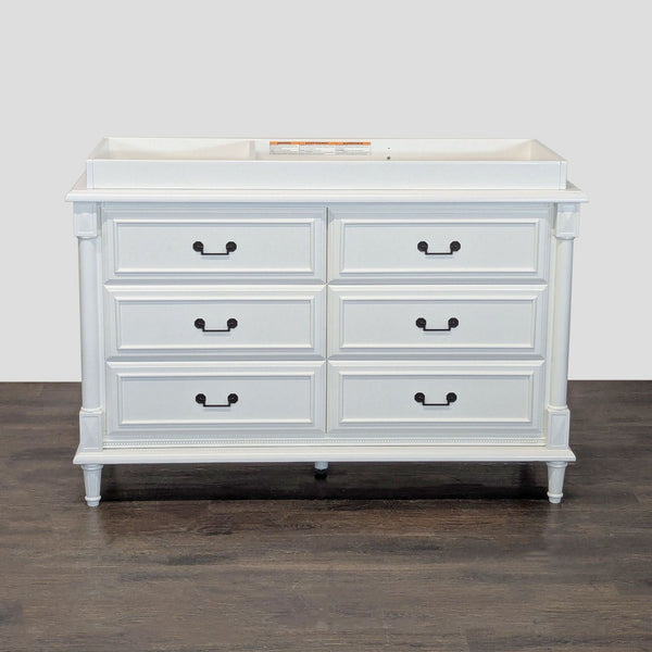 White six-drawer dresser with changing tray on top by Simmons Juvenile Furniture, perfect for nurseries.  