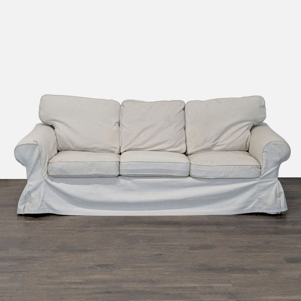 Ikea 3-seat sofa in light beige with soft cushions and removable cover, showing minor wear, overall good condition.  