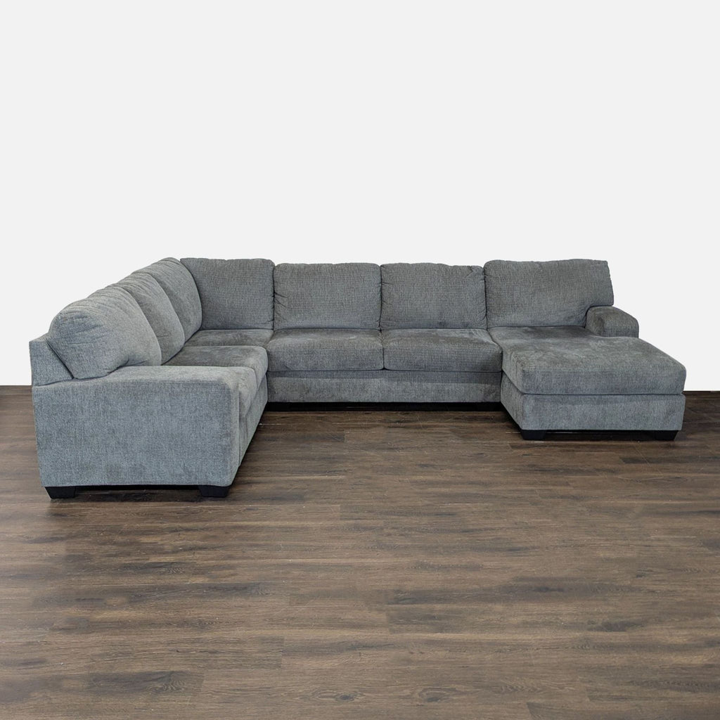 Modern Ashley Furniture sectional in gray fabric with chaise lounge, L-shape design, and spacious seating.  