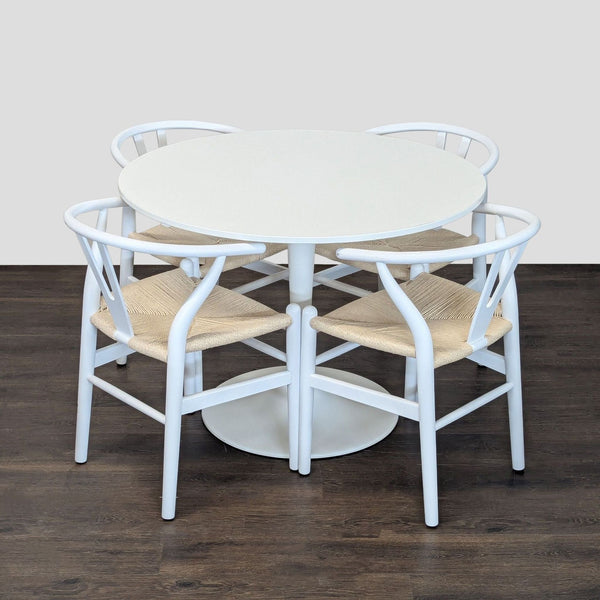 Round white Ikea dining set with four wishbone chairs featuring woven seats and modern style.  