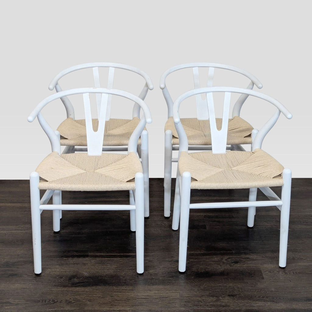 Ikea dining set: circular white table and four wishbone-style chairs with white frames and woven seats.  