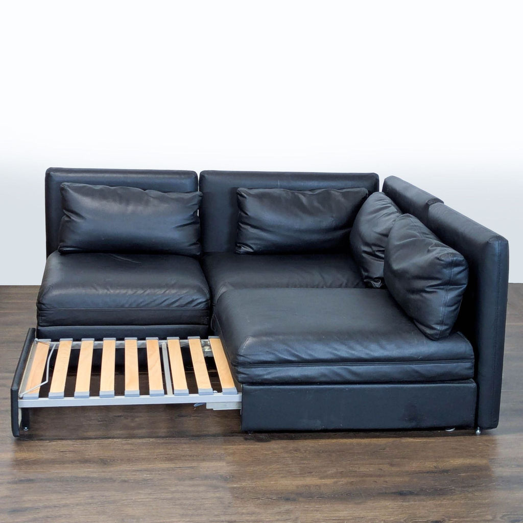 Sleek black corner sofa with soft upholstery, hidden storage, and sleeper feature for style and versatility.