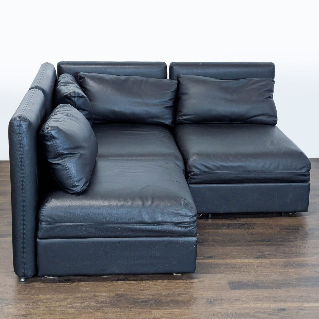 Excellent condition! 


Versatile modular sectional sofa is upholstered in black faux leather. This set includes a storage ottoman and a pull-out sleeper module. The modular design allows for various configurations to fit different living spaces. 

D