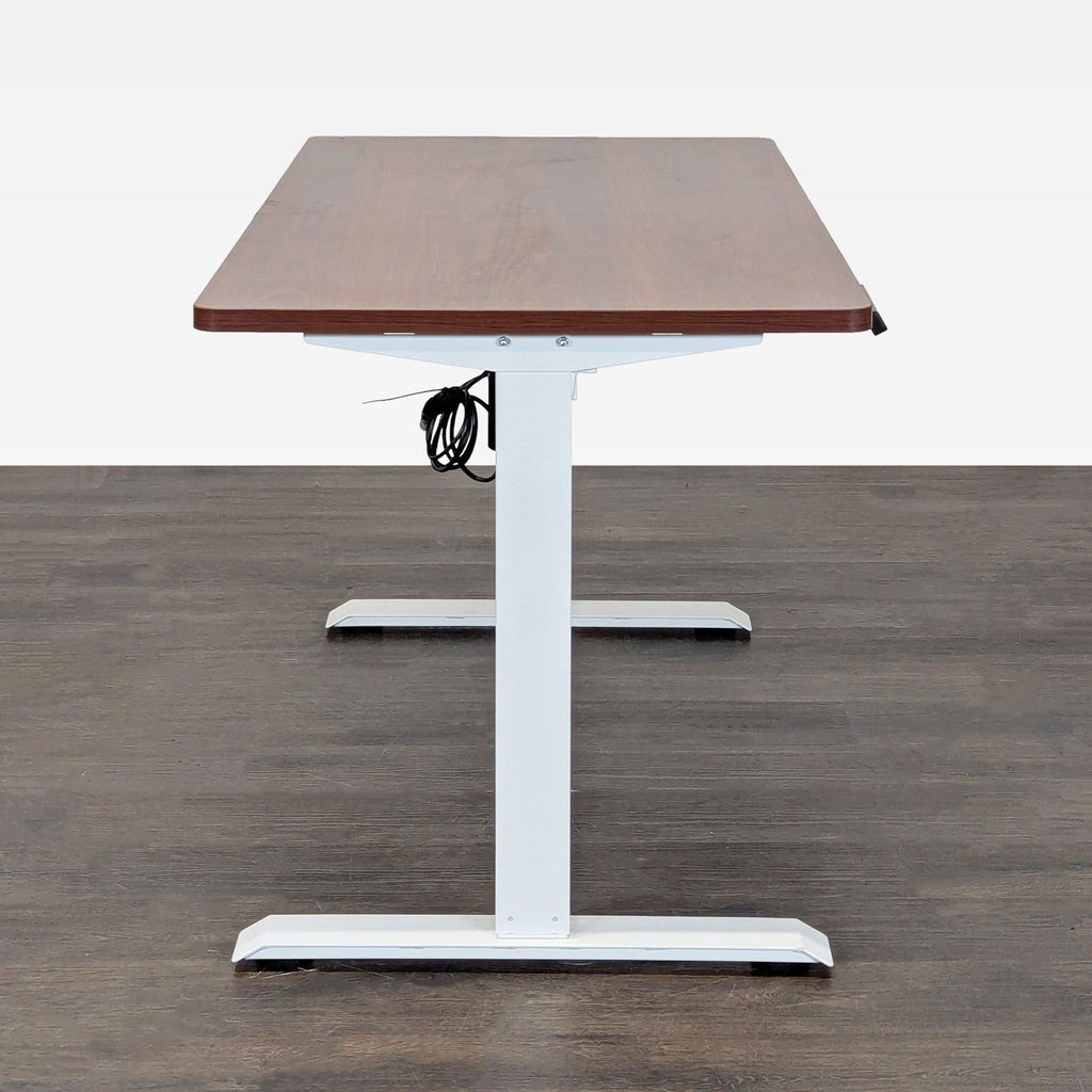 Electric sit-stand desk by Flexispot, with a large wooden tabletop and a strong white frame for office use.
