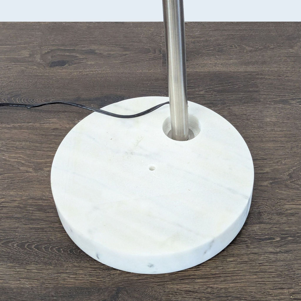 Elegant metal arc lamp with a fabric shade and marble base, ideal for brightening living rooms, bedrooms, or offices.