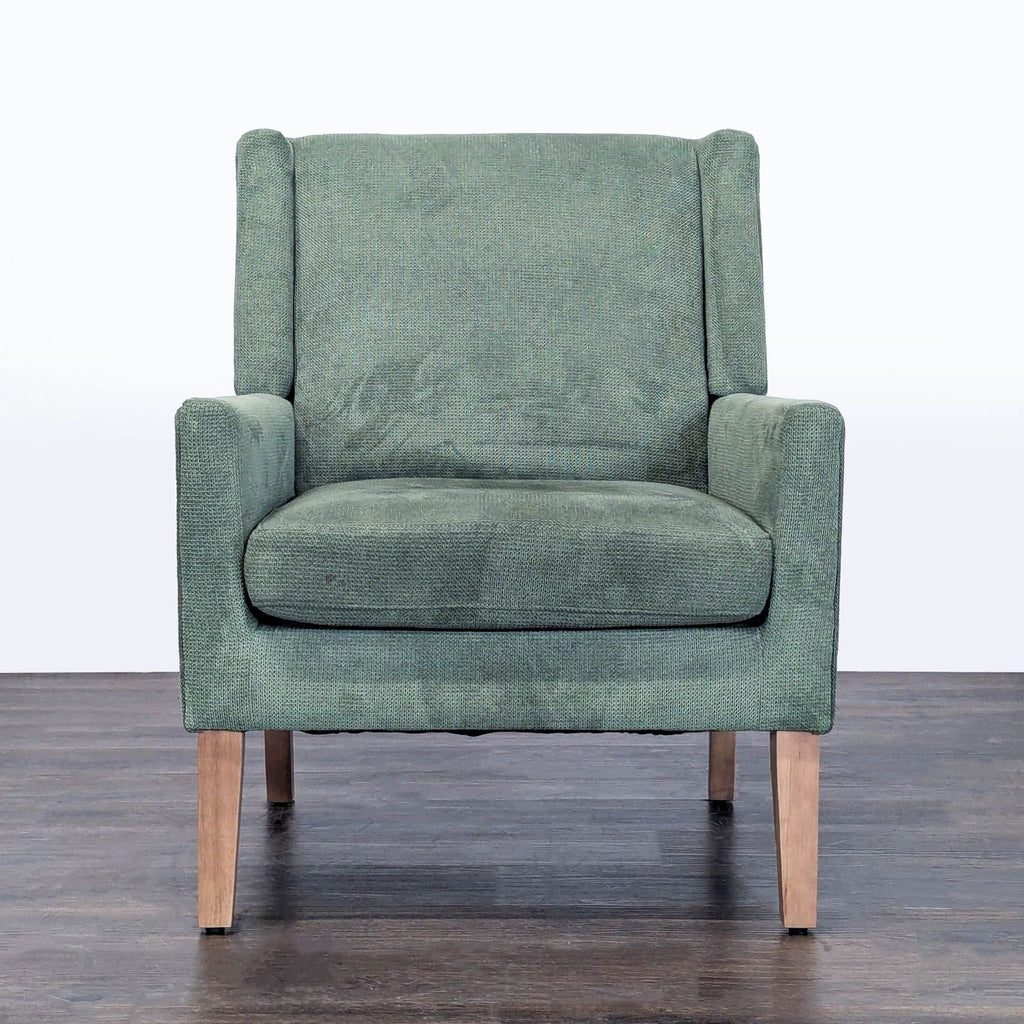 Colamy green fabric lounge chair with wooden legs, soft cushioned seat, and modern design.
