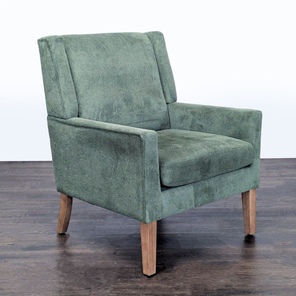 Modern Colamy lounge chair in green fabric featuring comfy padding and sturdy wooden legs.
