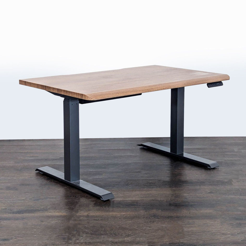 Vari standing desk with wood-style surface and metal legs, allowing easy height changes for ergonomic comfort.