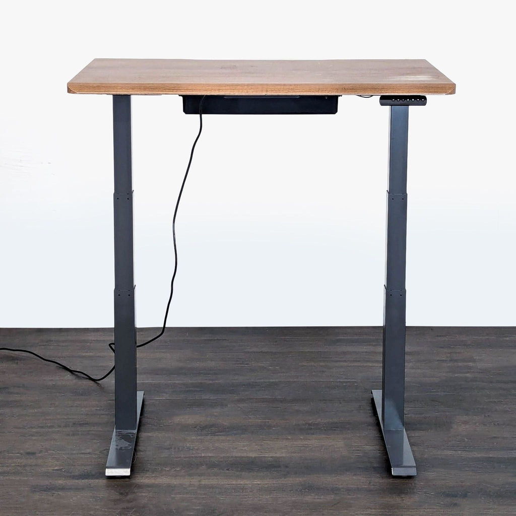 Modern adjustable desk by Vari, with wood finish, metal frame, and easy electronic controls for flexible workspace.