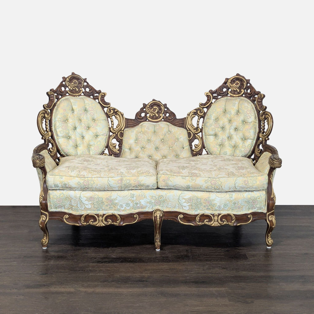 Hausske-Harlen vintage loveseat with carved wood frame, triple backrest, and floral tufted cushions.