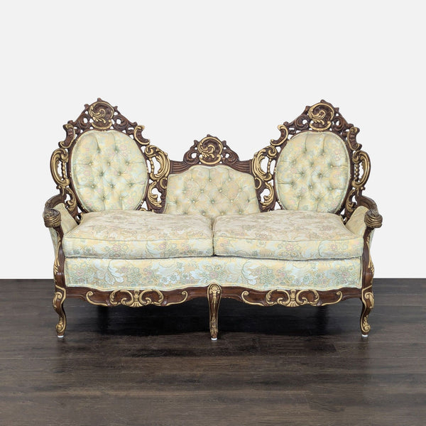 Hausske-Harlen vintage loveseat with carved wood frame, triple backrest, and floral tufted cushions.