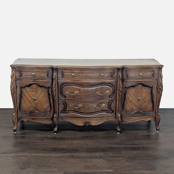 Vintage French Provincial sideboard with ornate brass handles and ample storage in drawers and cabinets.  