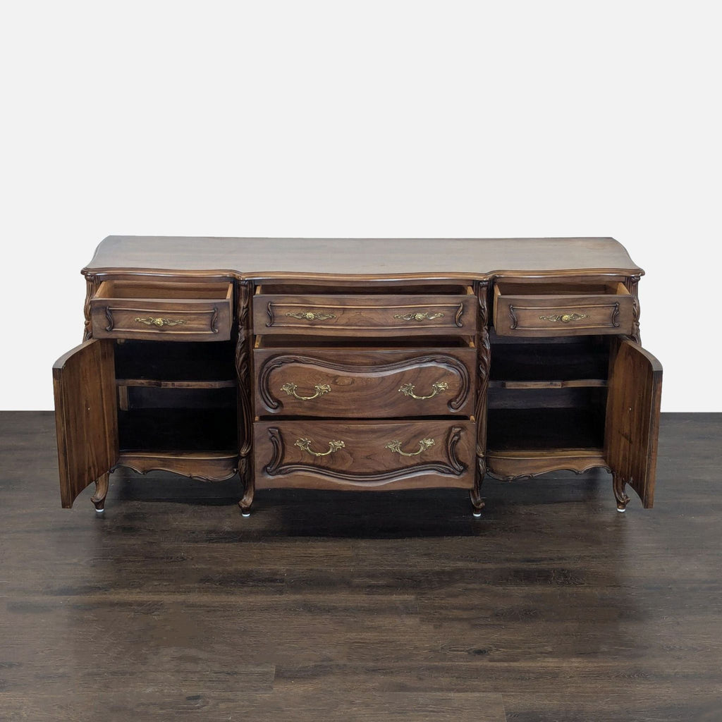 Classic wood grain sideboard featuring five drawers, two cabinets, and decorative brass hardware.  