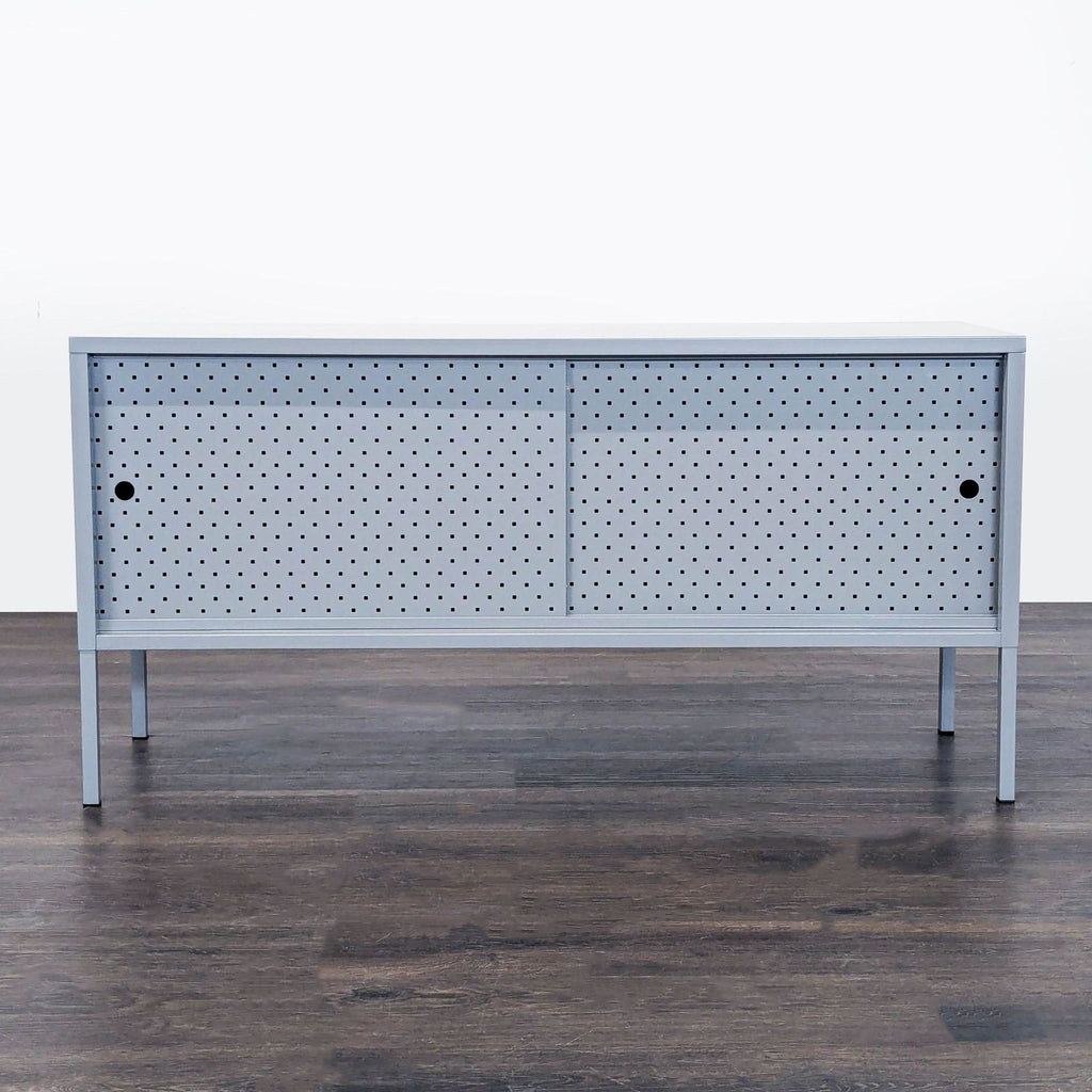 Minimalist Latitude Run entertainment center with steel mesh sliding doors and tall legs for an open look.