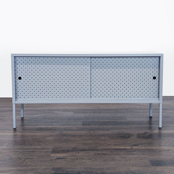 Minimalist Latitude Run entertainment center with steel mesh sliding doors and tall legs for an open look.