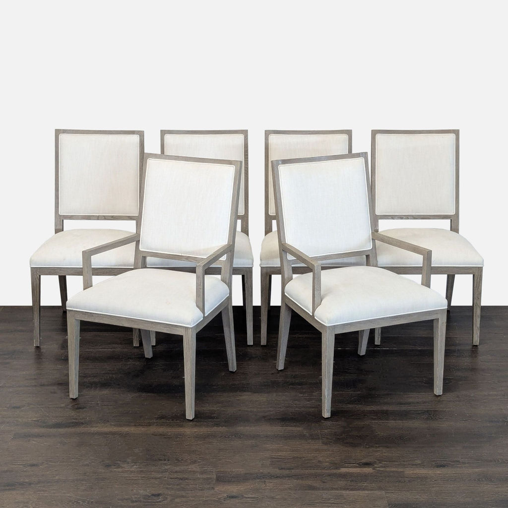Elegant marble-top dining table with six modern chairs, featuring soft upholstery and wooden frames.
