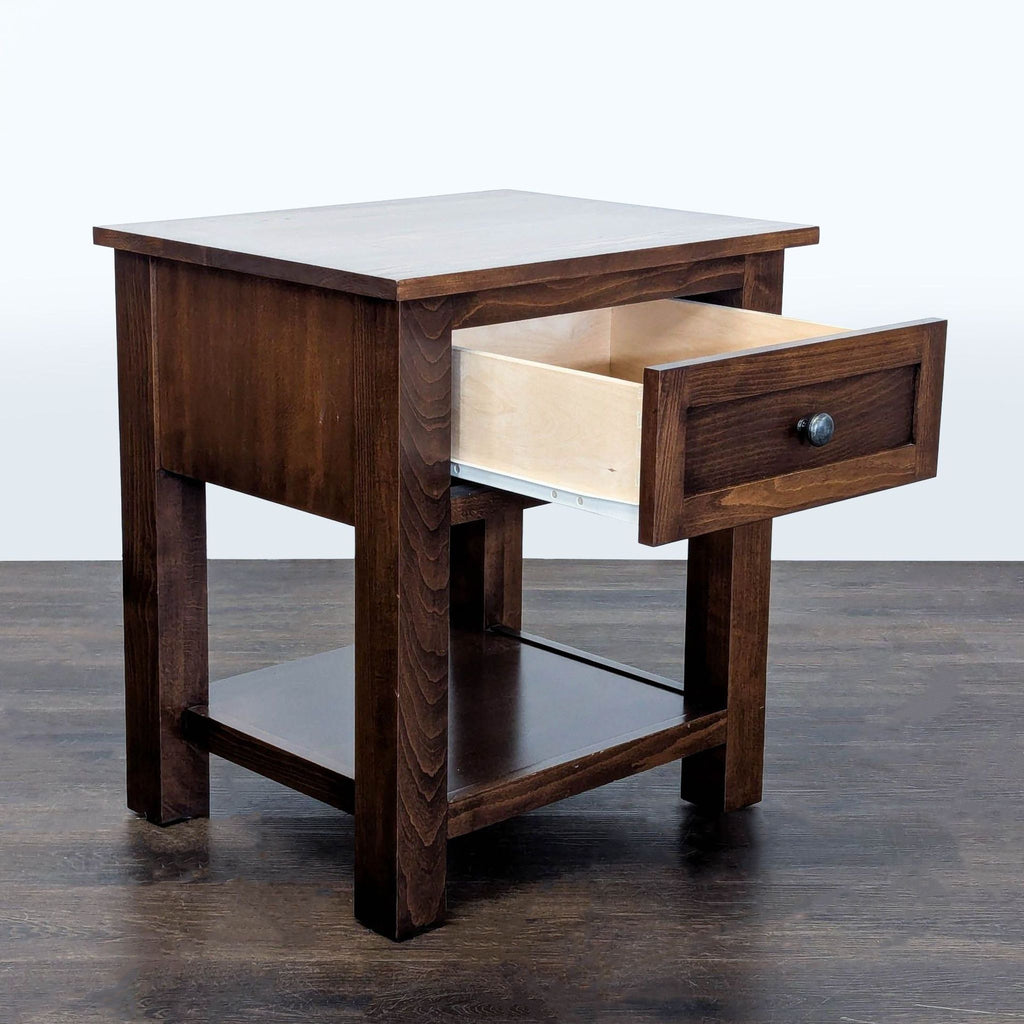 2. Sleek black metal end table with a glass top, styled next to a sofa in a living room.