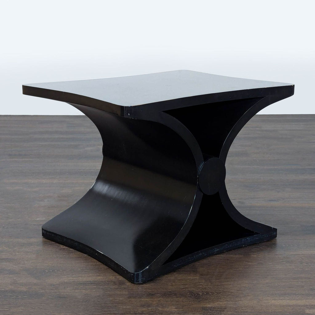 2. Sleek black metal end table with a glass top, styled next to a sofa in a living room.