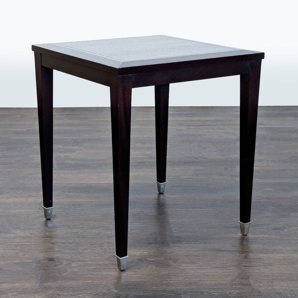 2. Sleek black metal end table with a glass top, styled next to a sofa in a living room.