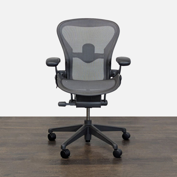 Herman Miller Aeron chair with mesh back, adjustable arms, and ergonomic support, ideal for office comfort.