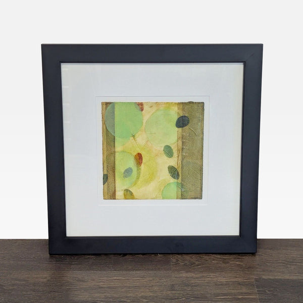 Abstract painting by Ines Kramer with soft green and earth-toned circles, framed and ready to hang.