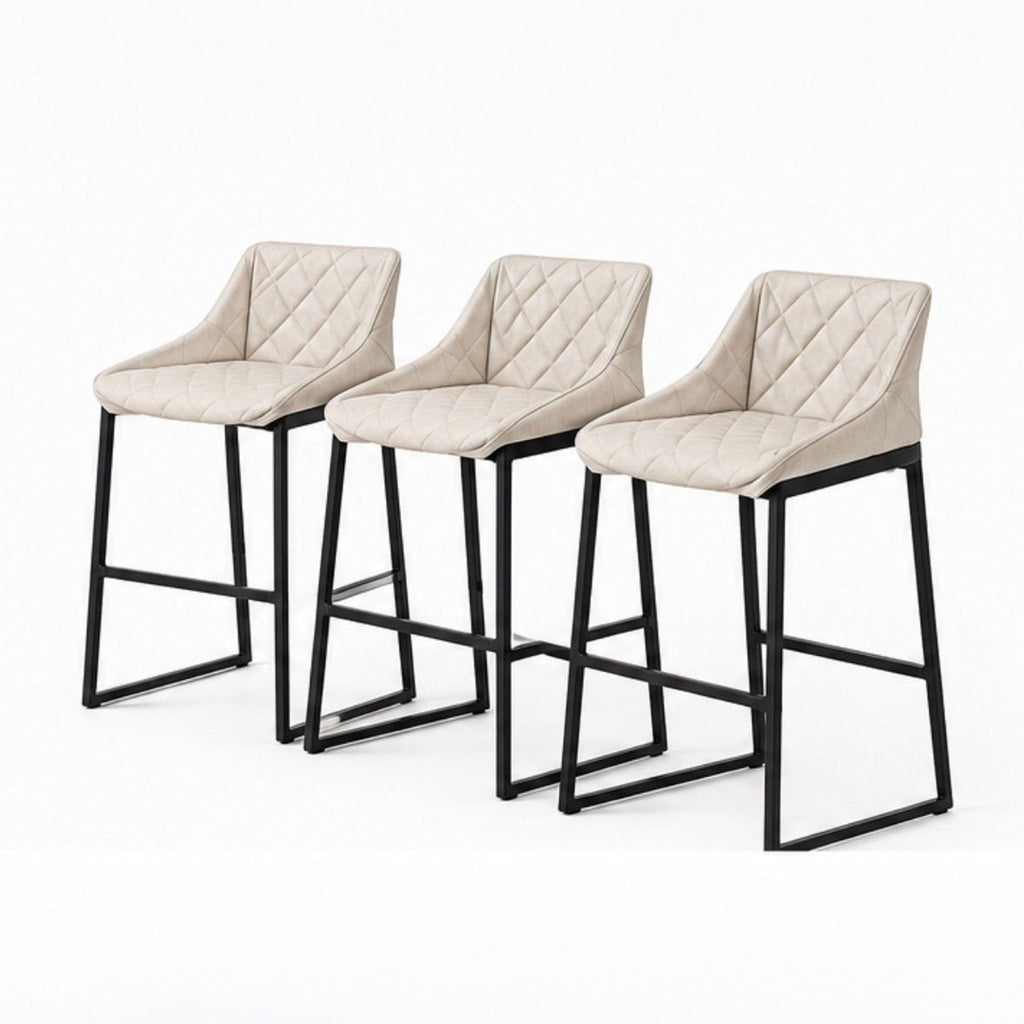 Trio of modern Studio Piet Boon stools, featuring quilted leather and powder-coated steel frames, angled view. 