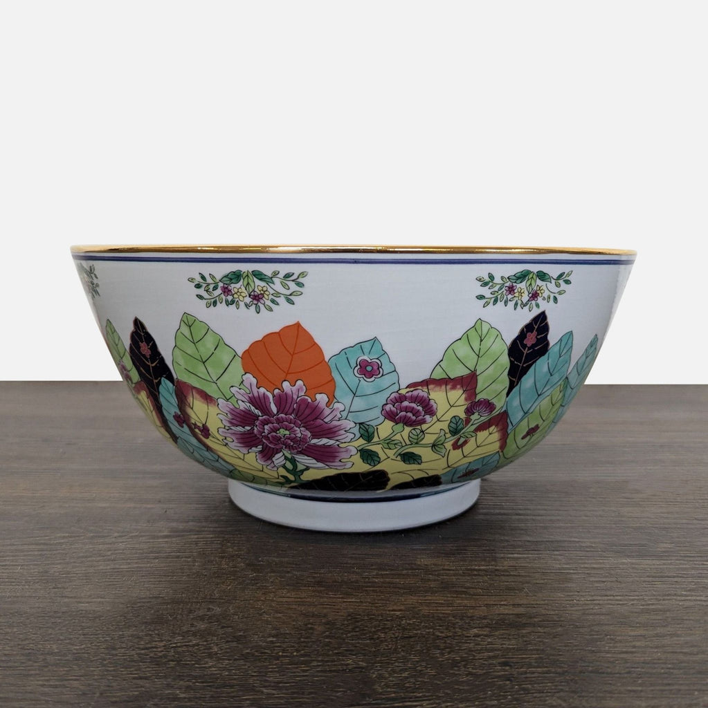 Porcelain bowl from Gumps Japan featuring vibrant floral and leaf patterns with a gold trim, dishware category.
