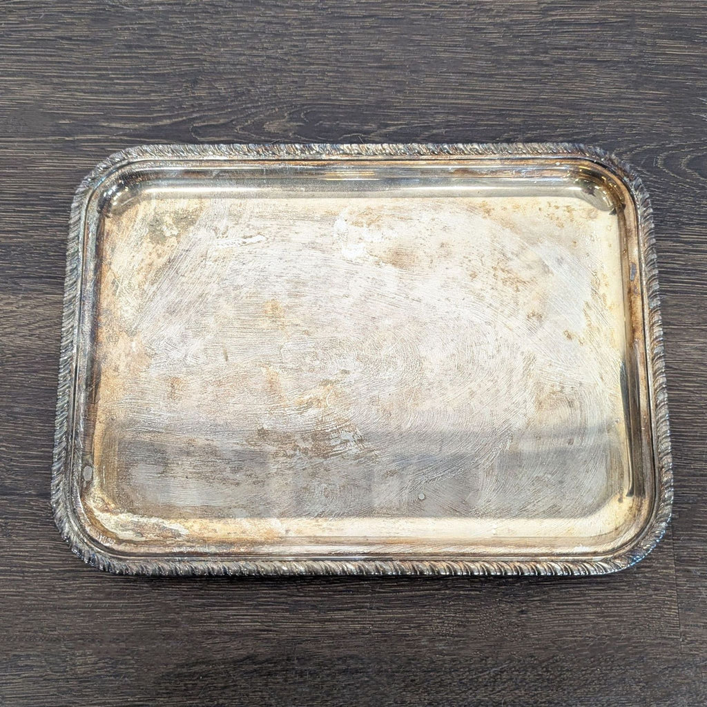 Rectangular silver-plated serving tray with decorative edge and vintage tarnish, suitable for drinks or snacks.