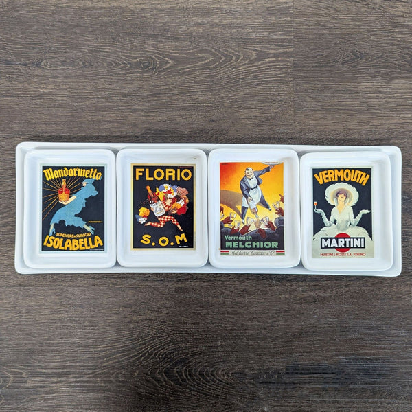 Set of four Pottery Barn mini trays featuring colorful vintage Italian drink posters on white ceramic.  