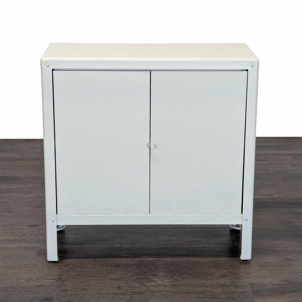 White Ikea cabinet with two doors and a central shelf, suitable for home or office storage use.