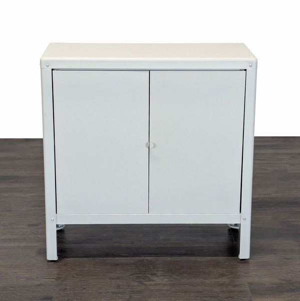 White Ikea cabinet with two doors and a central shelf, suitable for home or office storage use.