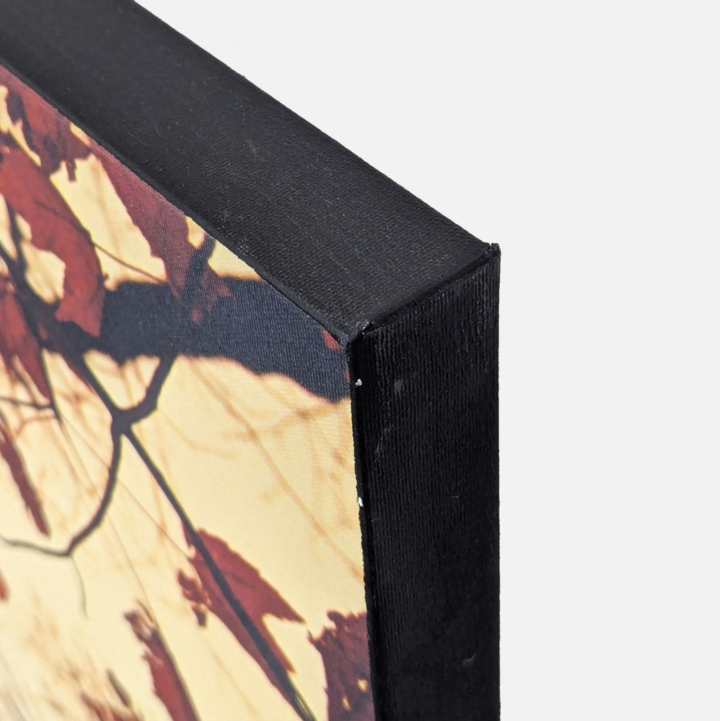 A Raymond Gehman canvas shows sharp, colorful maple leaves with a gentle sky backdrop and polished framed edges.