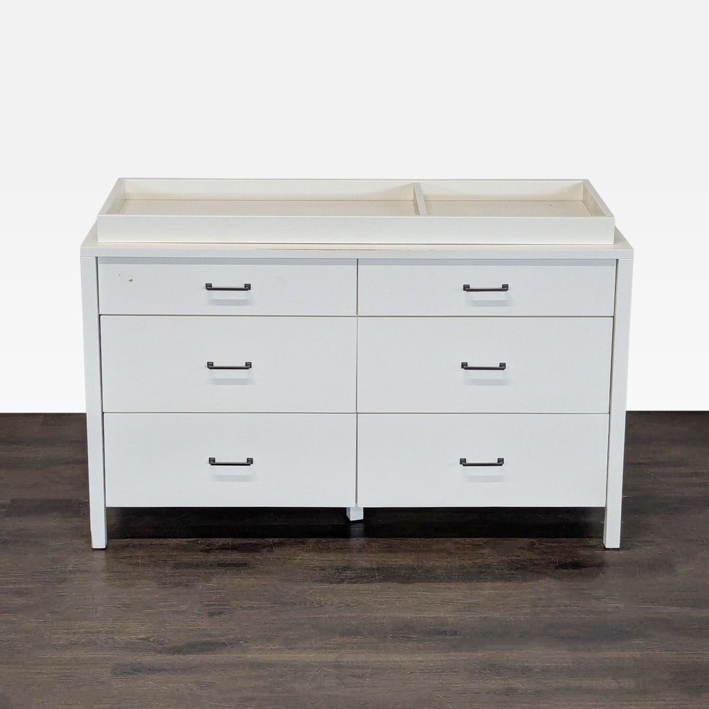 White Pottery Barn Kids dresser with six drawers and a changing tray, ideal for nursery storage.
