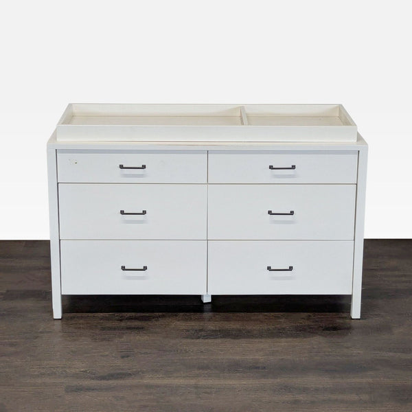 White Pottery Barn Kids dresser with six drawers and a changing tray, ideal for nursery storage.