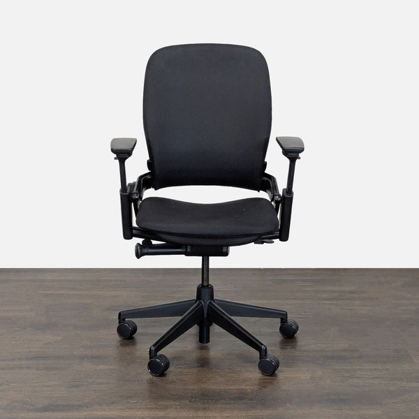Steelcase office chair with black fabric, adjustable armrests, and wheels, ideal for ergonomic desk support.