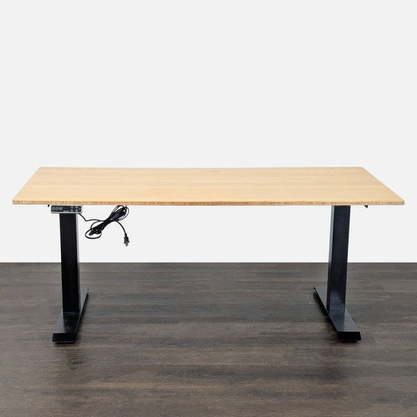 FlexiSpot bamboo standing desk with black metal frame, showing spacious top and electronic height controls.  